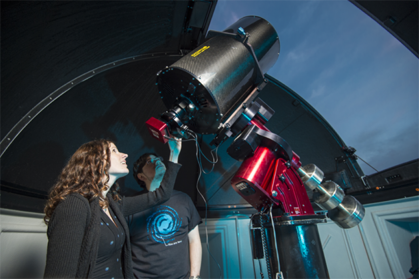 Dr. Collins is in the observatory looking through a telescope