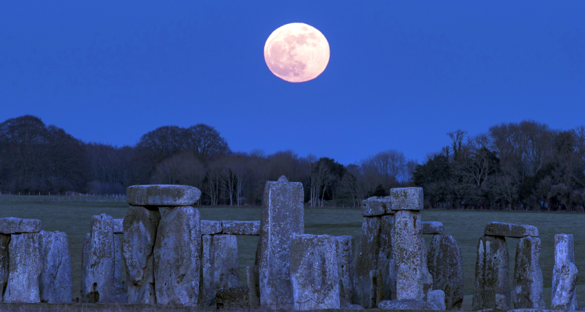 The Moon is pictured above Stonehenge.