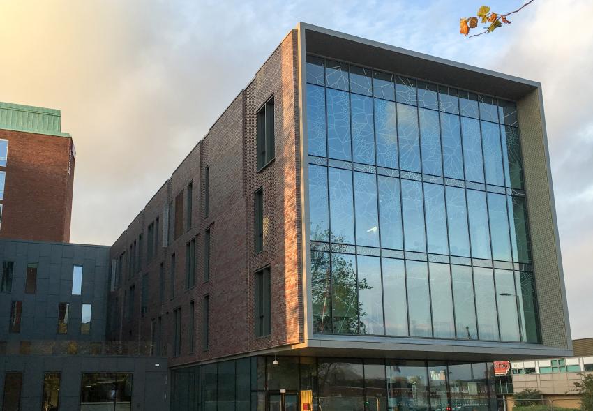 The exterior of the newly built and modern Schuster Building at University of Manchester.
