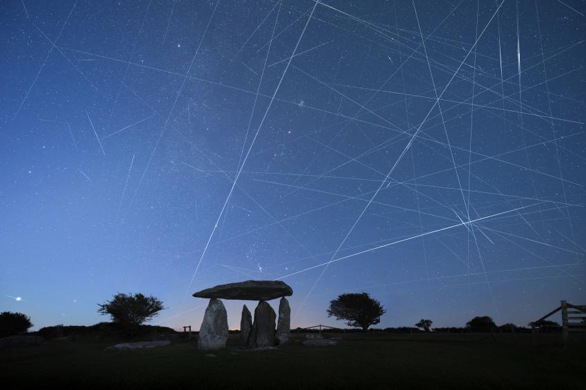 Not only can the Milky Way and constellations of Orion and Taurus be seen in this image, so too can trails left by numerous satellites crossing the sky, including those from the Starlink mega-constellation. The International Space Station and myriad other satellite and rocket bodies are also visible.
