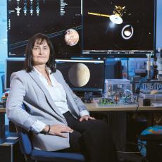 Prof Dougherty sitting in front of monitors showing space objects.