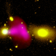 Three large blobs against the black backdrop of space. The one on the left is yellow, the middle is hot pink and shaped like a mushroom, and the one on the right is also yellow. The yellow blobs are galaxies and the pink is the radio jet being emitted from RAD12.