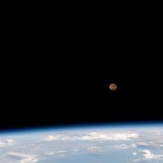 A view of the Moon rising above Earth's horizon as seen from the International Space Station.