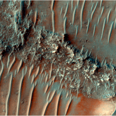 Colour image of a flat top, heavily eroded FSR. Sand dunes can be seen migrating over the top of the FSR.
