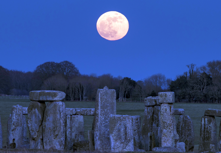 The Moon is pictured above Stonehenge.