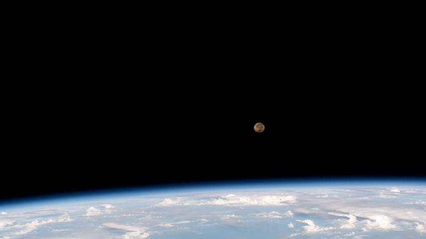 A view of the Moon rising above Earth's horizon as seen from the International Space Station.