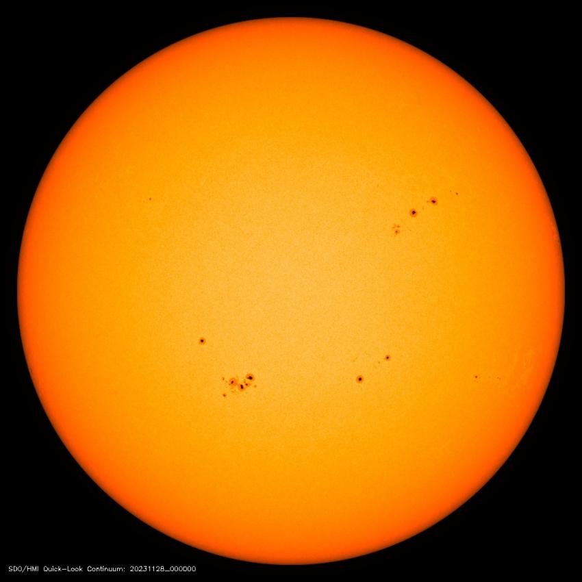 Image from the Solar Dynamics Observatory mission of the solar disk with multiple sunspots, which appear dark compared with their surroundings. Credit: HMI/SDO/NASA