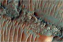 Colour image of a flat top, heavily eroded FSR. Sand dunes can be seen migrating over the top of the FSR.